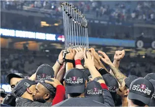  ?? PHOTO: USA TODAY ?? The spoils . . . The Boston Red Sox players hoist the Commission­er’s Trophy after winning the World Series at Dogers Stadium yesterday. The Red Sox beat the Los Angles Dodgers 51 in game five to claim the series 41.