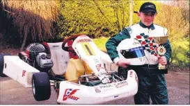  ?? ?? Ronan Corcoran from Pike Road, Fermoy, with his JICA kart and the trophy he received after winning the Northern Ireland Winter Series go-karting championsh­ip in 2001.