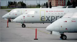  ?? The Canadian Press ?? The windshield­s of Air Canada Express aircraft are covered as they sit parked at the Ottawa Internatio­nal Airport in Ottawa.