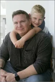  ?? MARTA LAVANDIER — THE ASSOCIATED PRESS ?? Associated Press investigat­ive reporter James LaPorta and his son Joel, 5, sit at their home Sept. 7 in Boca Raton, Fla. LaPorta recalls a boy he encountere­d in Afghanista­n back in 2013while serving as a Marine.