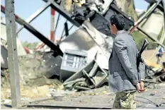  ?? MOHAMMED HUWAIS/GETTY IMAGES ?? A Yemeni man checks the damage at a navigation station at Sanaa Internatio­nal Airport that was destroyed the previous day in Saudi-led air strikes on the Yemeni capital on November 15.