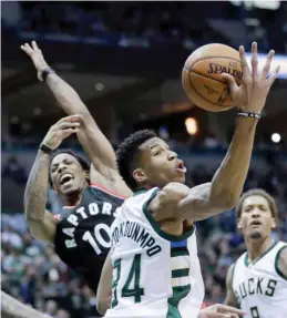  ?? — AP ?? MILWAUKEE: Milwaukee Bucks’ Giannis Antetokoun­mpo rebounds in front of Toronto Raptors’ DeMar DeRozan during the first half of Game 4.