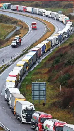  ??  ?? Nose to tail: Trucks queue along the A20 in Kent yesterday