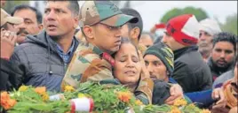  ?? AP ?? JCO Madan Lal Choudhary’s son Ankush Choudhary consoles his mother during former’s funeral in Kathua on Monday. The JCO was killed in Saturday's militant attack.