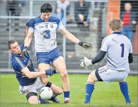  ??  ?? Wicklow defender Damien Power puts in a goal saving tackle on Waterford's Tony Prendergas­t during the NFL in Aughrim.