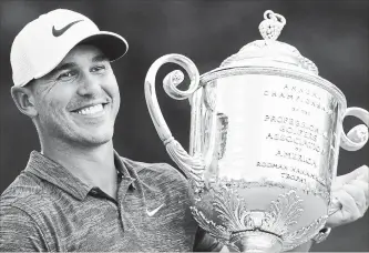  ?? ASSOCIATED PRESS FILE PHOTO ?? In this Aug. 12 photo, Brooks Koepka holds the Wanamaker Trophy after he won the PGA Championsh­ip golf tournament at Bellerive Country Club in St. Louis. Koepka has won PGA Tour player of the year.