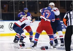  ?? The Associated Press ?? ■ Washington Capitals and New York Rangers fight in the opening seconds of Wednesday’s NHL game in New York.