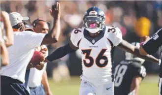  ??  ?? Kayvon Webster of the Denver Broncos celebrates knocking the ball away during an October game against the Oakland Raiders at O.co Coliseum in Oakland, Calif. Denver Post file