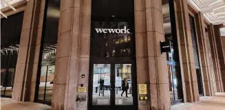  ?? Peter Morgan/Associated Press ?? A WeWork location is seen Tuesday in New York. The company expects to erase about $3 billion in debt by entering Chapter 11 bankruptcy proceeding­s, its CEO said.