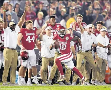  ??  ?? OKLAHOMA’S Steven Parker returns a fumble 46 yards for a fourth-quarter touchdown that gave the Sooners a 45-38 lead. The Bulldogs would later tie the score and set up the first overtime in Rose Bowl history.