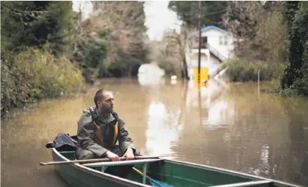  ?? Brian L. Frank / Special to The Chronicle ?? Jason Robinson of Guernevill­e needed a different kind of vehicle to travel on Neeley Road during Russian River flooding.