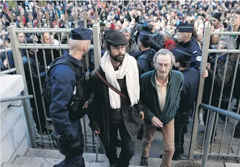  ?? Picture / AP ?? Cedric Herrou ( centre) told a judge who asked him why he helped migrants cross from Italy into France that he did it because “I am a Frenchman”.