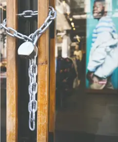  ?? SPENCER PLATT / GETTY IMAGES
FILES ?? A locked Levi’s store along Broadway in May as the coronaviru­s kept most businesses closed.