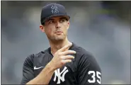  ?? AP PHOTO/ADAM HUNGER ?? New York Yankees pitcher Clay Holmes speaks to a reporter on the field before the first baseball game of a doublehead­er against the Los Angeles Angels on Thursday, June 2, 2022, in New York.