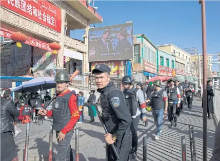  ?? AP ?? An armed civilian patrol in Hotan, in western China’s Xinjiang region, is shown in this November 2017 photo. Tibetan activists, housing petitioner­s and other campaigner­s are targets of China’s new campaign against ‘organised crime’.