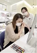  ?? The Yomiuri Shimbun ?? A customer of the Cosmetic Terrace store in Nishi Ward, Yokohama, applies her own makeup, a task that would have been done by the sales associate before the pandemic.