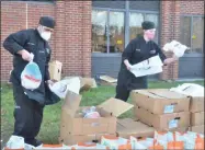  ?? PHOTOS BY LAUREN HALLIGAN — MEDIANEWS GROUP ?? A culinary arts student bags a turkey while assembling Thanksgivi­ng food packages for local families as part of the 2020Operat­ion Turkey project on Tuesday morning at the Washington-Saratoga-Warren-Hamilton-Essex BOCES F. Donald Myers Center in Saratoga Springs.