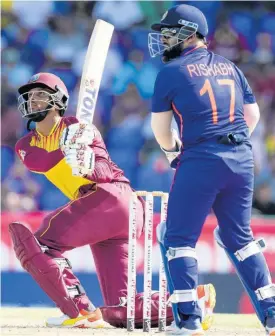  ?? AP ?? West Indies’ Brandon King hits a four as India’s wicketkeep­er Rishabh Pant looks on during the second T20 Internatio­nal cricket match at Warner Park in Basseterre, St Kitts and Nevis, yesterday.