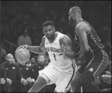  ?? Associated Press ?? New Orleans Pelicans forward Zion Williamson (1) dribbles the ball as Los Angeles Lakers forward LeBron James defends during the first half of an NBA game on Friday in Los Angeles.