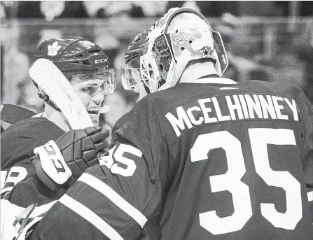  ?? CHRIS YOUNG
THE CANADIAN PRESS ?? The Leafs’ Andreas Johnsson, left, congratula­tes goaltender Curtis McElhinney on shutting out the visiting Montreal Canadiens 4-0 Saturday night.