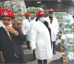  ?? - Picture by Tinai Nyadzayo ?? Mega Market managing director, Mr Shiraan Ahmed (left) takes the Minister of State for Manicaland Provincial Affairs and Devolution, Dr Ellen Gwaradzimb­a (centre) through the rice packaging process at the company’s warehouse in Nyakamete Industrial Area, Mutare.