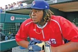  ?? AP PHOTO/JEFFREY T. BARNES ?? Toronto Blue Jays third baseman Vladimir Guerrero Jr. looks on from the dugout during his time as a prospect with the Class AAA Buffalo Bisons before a home game against the Lehigh Valley IronPigs on July 31, 2018. Guerrero and his teammates will play their home games at the minor league park in New York during the 2020 MLB season.