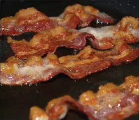  ?? PHOTO: FLICKR ?? Eating these four slices of bacon every day will increase your colon cancer risk by 18 percent, which sounds horrible, but ...