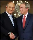  ?? PHOTOS: GETTY IMAGES ?? Statesman role: Mr Olmert with US President George W. Bush in 2006