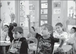  ?? AP/ HASSAN AMMAR ?? Displaced Syrian children participat­e in a lesson Tuesday at a school in Taanayel in Lebanon’s eastern Bekaa valley during a visit by the European commission­er for Humanitari­an Aid and Crisis Management.