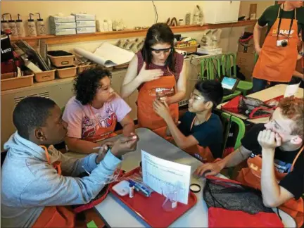  ?? PHOTOS BY NICHOLAS BUONANNO — NBUONANNO@TROYRECORD.COM ?? Students from Rensselaer Junior-Senior High School get some help from their teacher Kate Foley during their field trip to the BASF Environmen­tal Education Classroom and Wildlife Habitat facility in Rensselaer Tuesday morning.