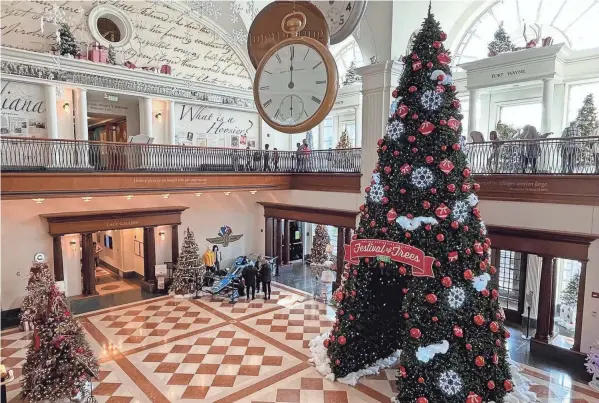  ?? STEVE STEPHENS PHOTOS/SPECIAL TO COLUMBUS DISPATCH ?? Christmas trees fill lovely Eli Lilly Hall at the Indiana Historical Society’s Festival of Trees.