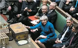  ?? JESSICA TAYLOR/AP ?? After winning a no-confidence vote, Prime Minister Theresa May, who leads a fractious government, a divided Parliament and a gridlocked Brexit process, says she will stay.