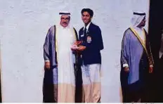  ?? Clint Egbert/Gulf News ?? Shaikh Hamdan presents an award to Gautam Pillai. A total of 375 people applied for the award this year and 248 winners were chosen. ■