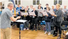  ?? ?? Ars Nova and their director Christophe­r Luke rehearsing for Taranaki Sings. They’re one of seven choirs who’ll be taking to the streets with sweet Taranaki songs.