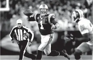  ?? Associated Press ?? Carolina Panthers quarterbac­k Cam Newton scrambles with the ball against the Washington Redskins on Nov. 22 in Charlotte, N.C.