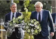  ?? ASSOCIATED PRESS ?? British Prime Minister Boris Johnson (right) and Labour Party leader Keir Starmer arrive at the church where a member of Parliament was stabbed to death Friday during a meeting with constituen­ts.