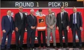  ?? MICHAEL AINSWORTH — THE ASSOCIATED PRESS ?? Jay O’Brien of the United States, center, was drafted by the Philadelph­ia Flyers during the NHL hockey draft in Dallas, Friday night.