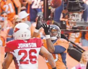  ??  ?? Broncos tight end Julius Thomas pulls in one of his seven TD receptions this season, victimizin­g the Arizona Cardinals’ Rashad Johnson. John Leyba, The Denver Post