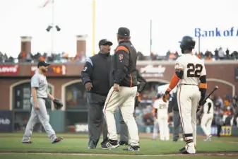  ?? Ezra Shaw / Getty Images ?? Giants manager Bruce Bochy argues with umpire Laz Diaz after Miami’s Dan Straily hit Buster Posey in the second inning. Straily and Marlins manager Don Mattingly were ejected.