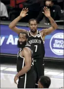  ?? AP photo ?? Kevin Durant of the Nets celebrates with James Harden during the second half of Brooklyn’s 125-123 victory over the Milwaukee Bucks on Monday.