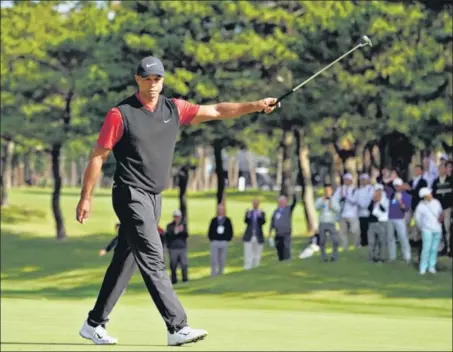  ?? AP ?? Tiger Woods reacts after his birdie putt at the 18th hole during the final round of the Zozo Championsh­ip at the Accordia Golf Narashino Country Club in Inzai on Monday.