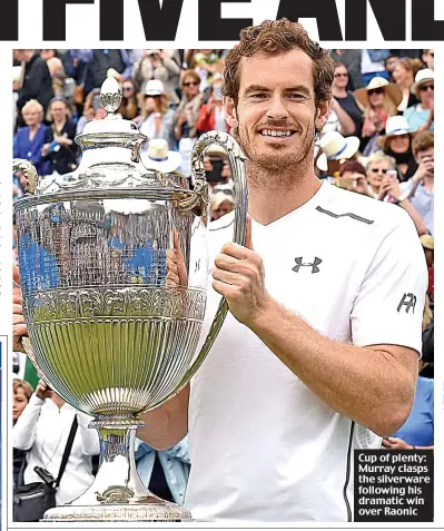  ??  ?? Cup of plenty: Murray clasps the silverware following his dramatic win over Raonic