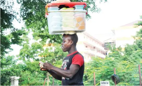  ??  ?? A boy hawks food along a major street in Jabi, Abuja yesterday. Photo Ikechukwu Ibe