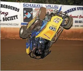  ??  ?? Above, Brian Boyer Jr. (#71B) climbed the backstretc­h wall and went for a nasty flip in the 125 Micro Sprint main event. Boyer was unhurt but the car was done for the night. Below, A trio of 270 Micro Sprints come off of turn four three abreast. From...