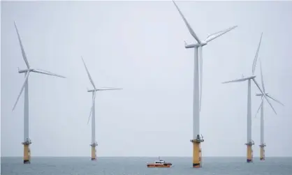  ??  ?? An engineerin­g vessel among the EDF offshore windfarm at Teesport, England. Photograph: Ian Forsyth/Getty Images