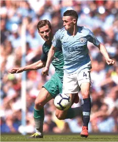  ?? — AFP photo ?? Manchester City’s English midfielder Phil Foden (right) takes on Tottenham Hotspur’s Belgian defender Jan Vertonghen during the English Premier League football match between Manchester City and Tottenham Hotspur at the Etihad Stadium in Manchester, north west England.