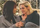  ?? HULU ?? Mackenzie Davis, left, and Kristen Stewart star in Happiest Season, about a woman who struggles to come out to her parents during Christmas.