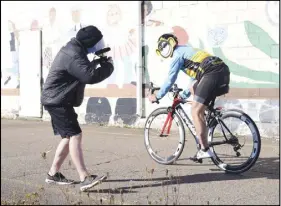  ?? CODY MCEACHERN/TRURO DAILY NEWS ?? Ettnie Webster, student videograph­er for the Hubtown Ad Challenge, works on capturing the perfect shots of various bike riders for the Bike Monkey commercial. Each rider wore a mask of Bike Monkey’s logo, a theme that was carried throughout the...