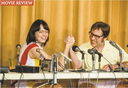  ?? Melinda Sue Gordon / Fox Searchligh­t Pictures ?? Above: Emma Stone and Steve Carell get a grip in a “Battle of the Sexes” scene.