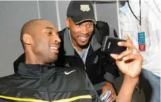 ?? ANDREW D. BERNSTEIN/GETTY IMAGES FILE ?? Laker Kobe Bryant shows Byron Scott a photo during NBA all-star weekend in 2008. Scott reportedly has a four-year deal to coach Bryant’s Lakers.